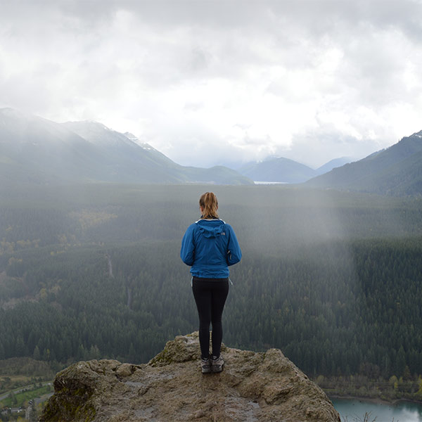 A woman on top of the mountain.
